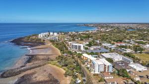 an aerial view of a beach with buildings and the ocean at 404b Coral Sands in Bargara