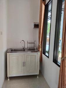 a kitchen with a sink and a window at Palm Tian Homes A17 in Ban Chong Phli