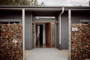 a house entrance with a bunch of logs at Tocumwal Chocolate School in Tocumwal