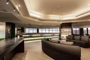 a living room with a couch and a table at Hub Hotel - Songshan Airport Branch in Taipei