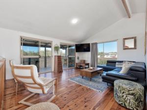 a living room with a couch and a chair at 242 Woongarra Scenic Drive in Bargara
