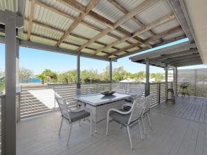 a patio with a table and chairs on a deck at 242 Woongarra Scenic Drive in Bargara