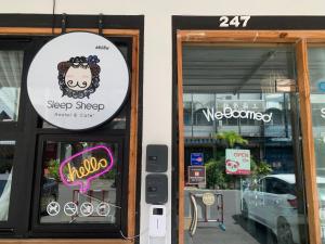 a store front with a sign on the door at Sleep Sheep Phuket Hostel SHA in Phuket Town