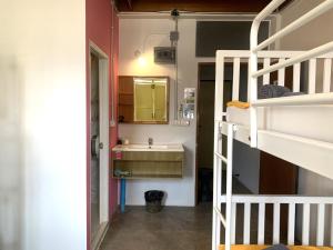 a small bathroom with a sink and a bunk bed at Sleep Sheep Phuket Hostel SHA in Phuket Town
