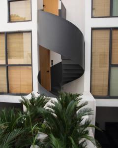 a spiral staircase on the side of a building at Casa Pani in Mexico City
