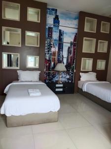 a bedroom with two beds and a view of a city at Mojokerto Classic Homestay in Mojokerto