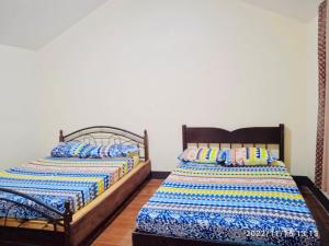 Postel nebo postele na pokoji v ubytování Miguel's Homestay