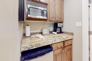 a kitchen with a counter top with a microwave at Sidewinder Sunshine in Park City
