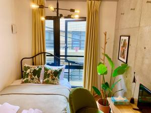 a bedroom with a bed and a large window at Ken's Place四谷 in Tokyo