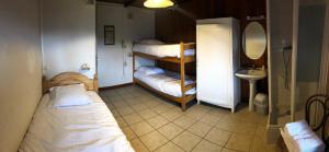 a room with two bunk beds and a sink at Auberge de Pra-Loup in Pra-Loup