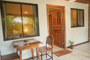 a room with a table and a chair and a door at GALA Santa Teresa Studios - Walk to Beach & Surf in Santa Teresa Beach +44 photos