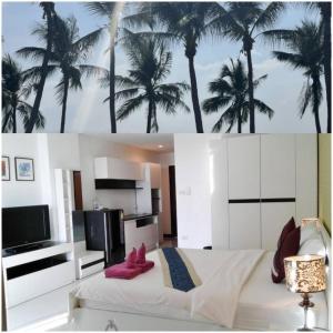 a bedroom with a bed with palm trees on the wall at Grand Residence Jomtien in Jomtien Beach