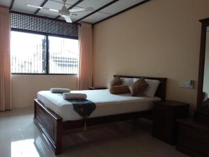 a bedroom with a bed and a large window at Colombo Residence in Colombo