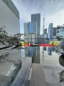 a swimming pool with a city skyline in the background at Happy Home in Nha Trang