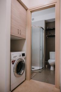 a washer and dryer in a bathroom with a toilet at Nafplio Pleasure Stay Ι in Nafplio