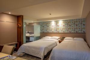Katil atau katil-katil dalam bilik di Rich & Free Hotel - Kaifeng 富逸旅趣-北車開封館