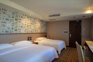 Katil atau katil-katil dalam bilik di Rich & Free Hotel - Kaifeng 富逸旅趣-北車開封館