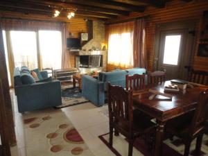 a living room with couches and a table in a room at Katoikies Aiolos in Kato Trikala Korinthias