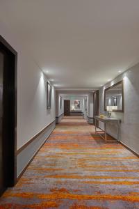 a long hallway with a rug on the floor at Southern Star,Bangalore in Bangalore