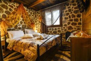 カト・トリカラ・コリンティアスにあるKatoikies Aiolosの石壁のベッドルーム1室(ベッド1台付)