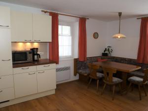 a kitchen with a table and a dining room at Holiday flat Sonnau, Bramberg am Wildkogel in Bramberg am Wildkogel