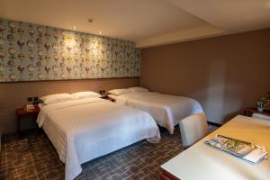 Katil atau katil-katil dalam bilik di Rich & Free Hotel - Kaifeng 富逸旅趣-北車開封館 +19 gambar