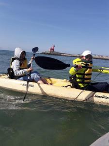two people sitting on a kayak in the water at Sogobe Cabin in Jeju