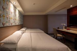 Katil atau katil-katil dalam bilik di Rich & Free Hotel - Kaifeng 富逸旅趣-北車開封館