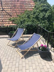 two blue lounge chairs sitting on a patio at Városi Menedék in Veszprém