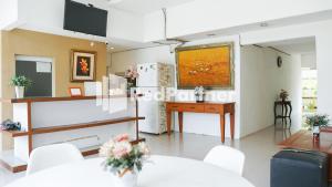 a living room with a table and a large painting on the wall at El Dhiya Syariah Karawaci RedPartner in Tangerang