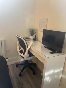 a white desk with a computer monitor and a chair at Pods of Kings Cross -1 in London