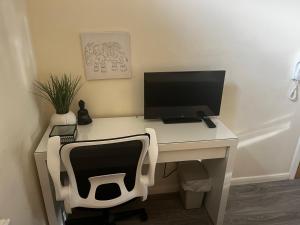 a desk with a computer and a monitor and a chair at Pods of Kings Cross -1 in London