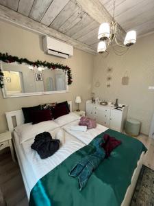 Un dormitorio con una gran cama blanca con ropa. en Smaragd en Doba