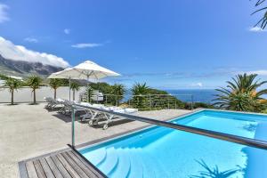 a swimming pool with a view of the ocean at Ocean View House in Cape Town