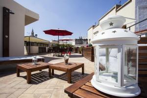 a white lantern sitting on a patio with two tables at Hostal Callejon del Agua in Seville