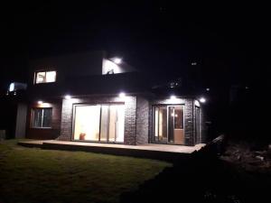 a brick house at night with lights on it at Sogobe Jeju House in Jeju