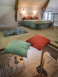 a bedroom with a bed and two pillows on the floor at Les Hauts de Bagadou in Martel +25 photos