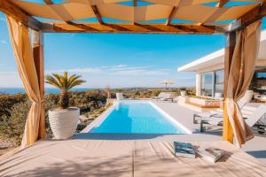 a view of the pool from the patio of a villa at Luxury villas on Island Pag - Plant Villas Novalja in Novalja