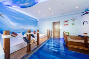 a bedroom with a pool in the middle of the room at Rococo Homestay in Hengchun