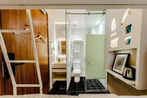 a bathroom with a shower and a toilet in a room at D'Nova Hotel Bugis in Singapore