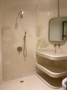 a bathroom with a mirror and a sink at CASA NARA BALI in Munggu