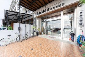 a store front with two bikes parked outside of it at Rococo Homestay in Hengchun