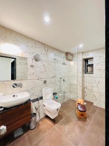 a bathroom with a sink and a toilet at LEELA BIZOTEL in Junagadh