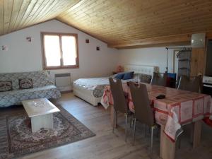 a room with a bed and a table and chairs at Appartement Nicole BENKOVAC in Benkovac