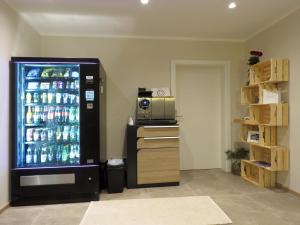 a soda machine in a room with a refrigerator at Jagerwirt rooms in Völkermarkt