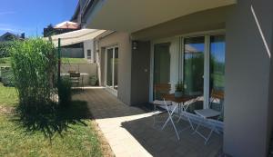 a patio with a table and chairs next to a house at A Home away from Home in Ravensburg