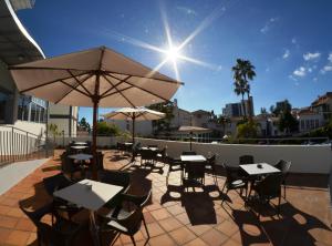 
a patio area with tables, chairs and umbrellas at Madeira Bright Star by Petit Hotels in Funchal
