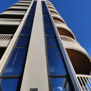 a tall building with glass windows on the side at Residence Atlantico in Lido di Jesolo