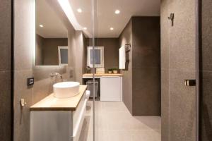 a bathroom with a sink and a glass shower at Downtown Syntagma apartment 3 in Athens