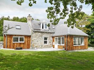 a home with a stone and wood exterior at Easter Lettoch in Advie